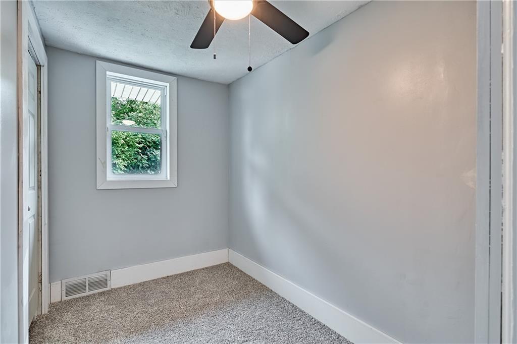 408 20th Street Beaver Falls, PA 15010 - Photo 21 of 27 an empty room with a window and a ceiling fan