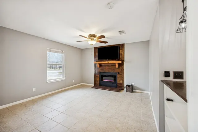 a view of an empty room with a window and a flat screen tv
