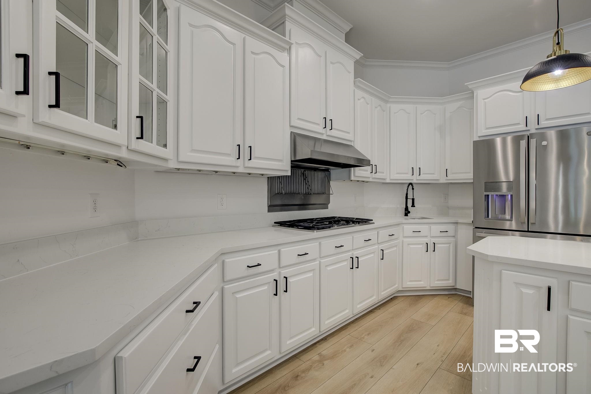 105 High Pines Ridge Fairhope, AL 36532 - Photo 31 of 97 Kitchen with under cabinet range hood, stainless steel fridge with ice dispenser, gas cooktop, glass insert cabinets, and white cabinets