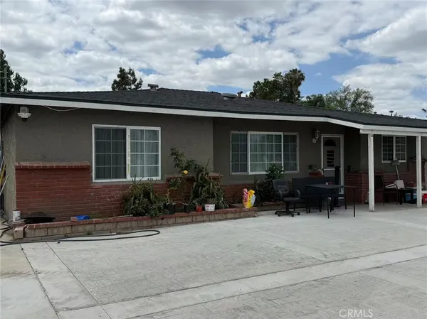a front view of house with outdoor seating