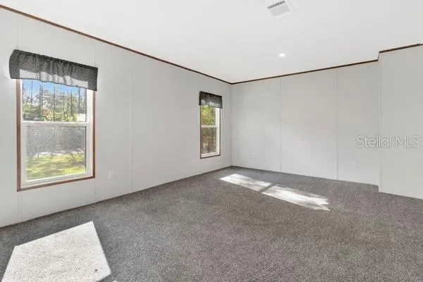 an empty room with windows and closet