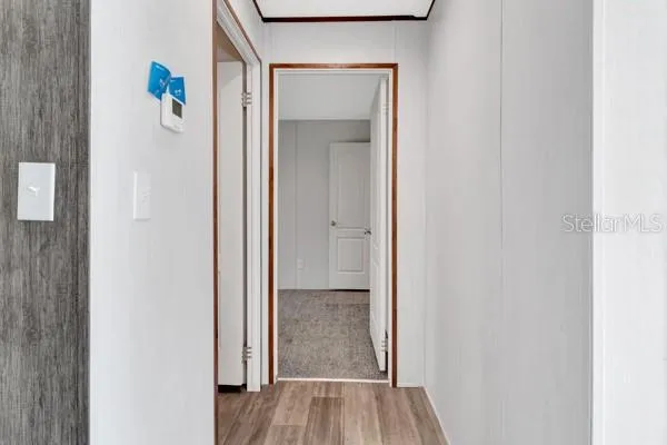 a view of a hallway with wooden floor