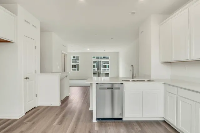 a kitchen with kitchen island sink stove and cabinets