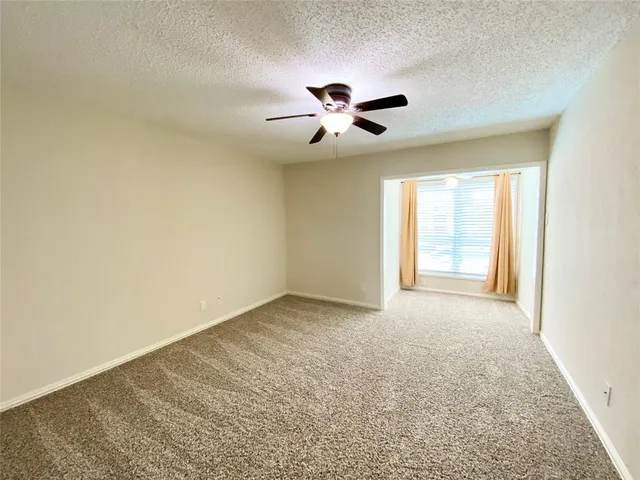 a view of an empty room and a window