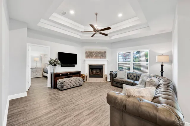 a living room with furniture a flat screen tv and a fireplace