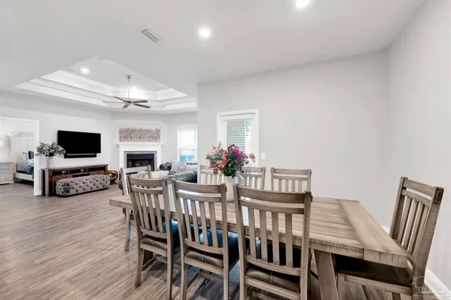 a view of a dining room with furniture and a flat screen tv