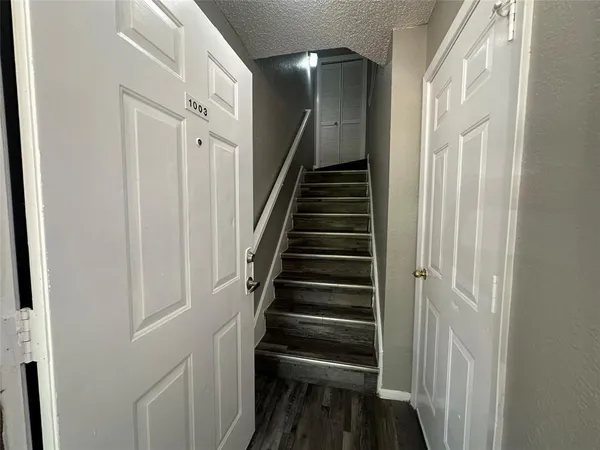 a view of entryway and gallery with wooden floor