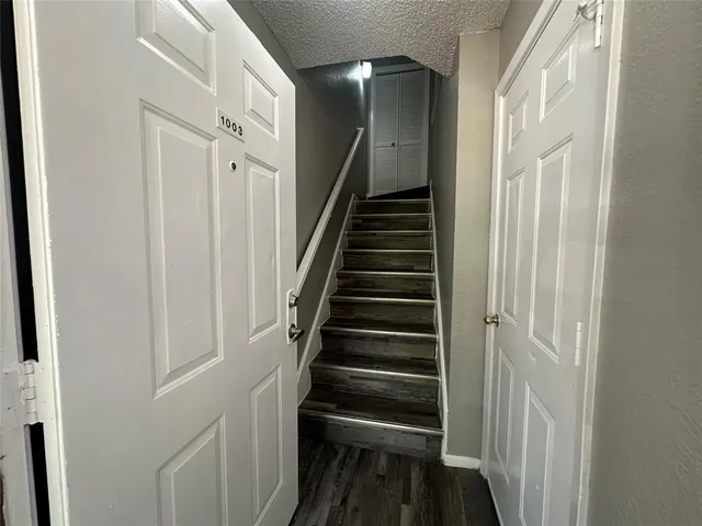 a view of entryway and gallery with wooden floor