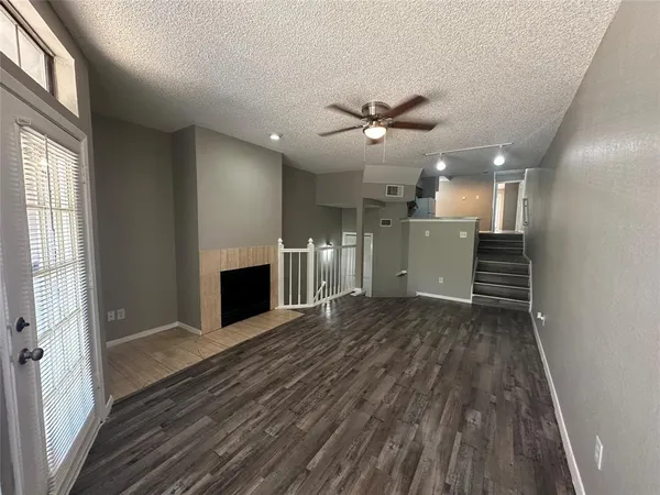 wooden floor in an empty room with a fireplace
