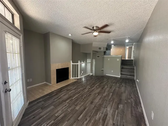 wooden floor in an empty room with a fireplace