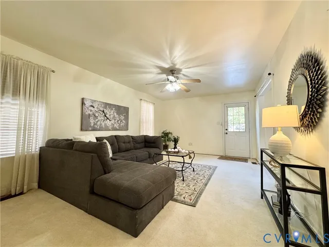 a living room with furniture and a chandelier