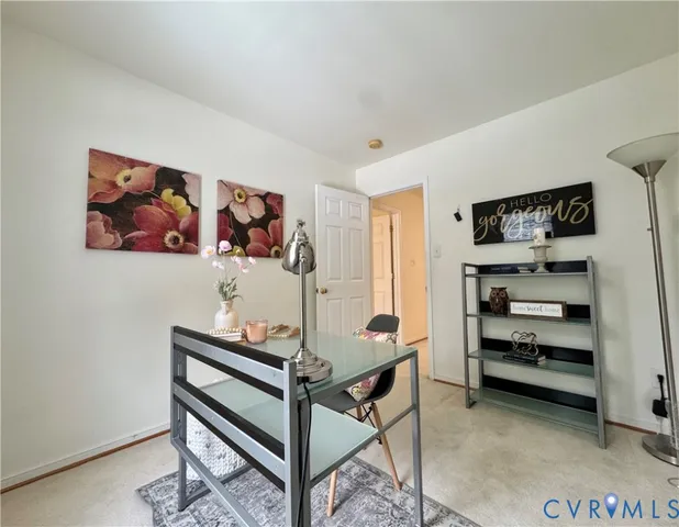 a room with a table and a painting on the wall