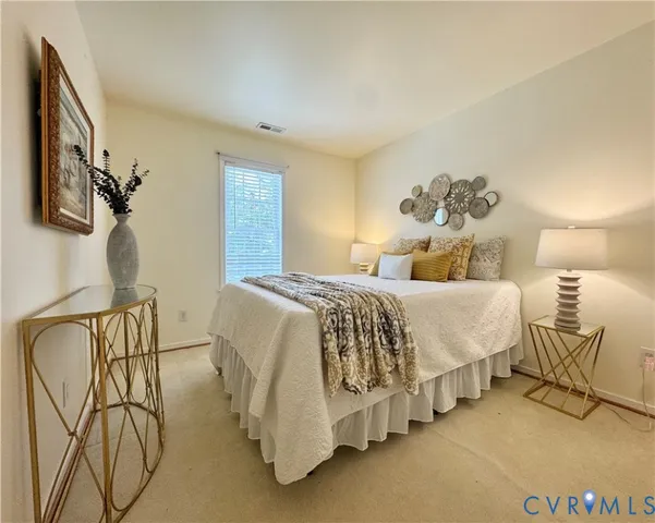 a bedroom with a bed and lamp