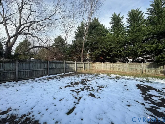 a view of wooden fence and trees