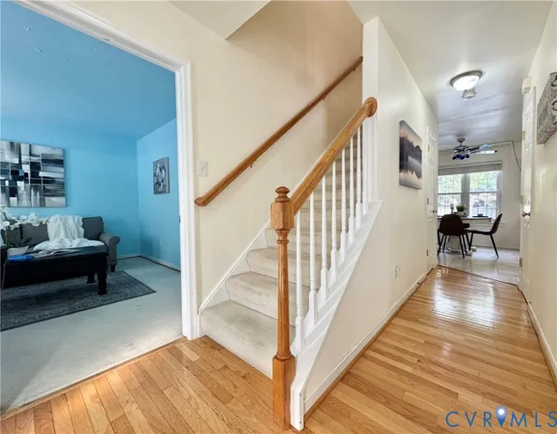 a view of entryway and hall with wooden floor