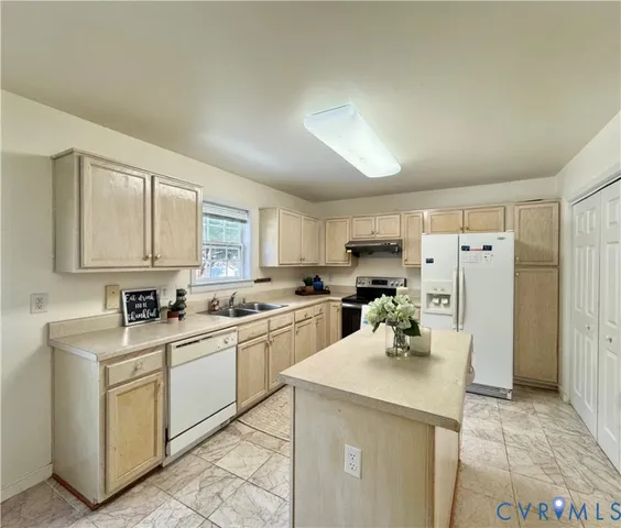 a kitchen with a sink cabinets and refrigerator