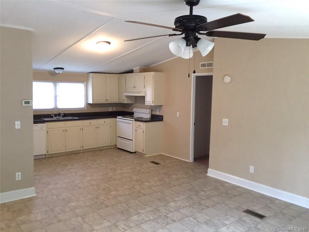 1915 Burkin Road McConnells, SC 29726 - Photo 6 of 16 a kitchen with stainless steel appliances granite countertop a sink a stove a refrigerator a microwave and cabinets