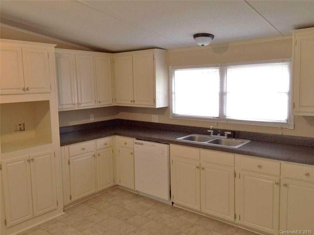 1915 Burkin Road McConnells, SC 29726 - Photo 7 of 16 a kitchen with granite countertop white cabinets and sink