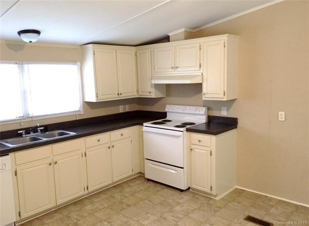 1915 Burkin Road McConnells, SC 29726 - Photo 8 of 16 a kitchen with granite countertop white cabinets and white appliances