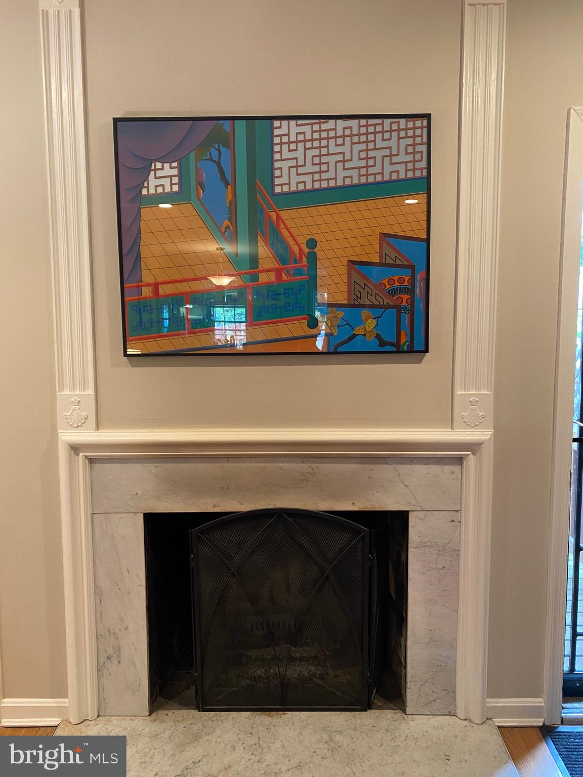 339 11th Street Southeast Washington, DC 20003 - Photo 34 of 39 a living room with a fireplace and a painting on the wall