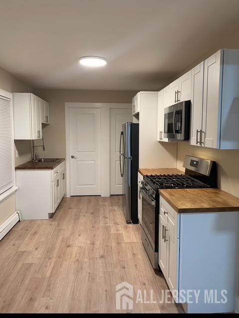 165 Emerson Street, Unit 2 Carteret, NJ 07008 - Photo 4 of 10 a kitchen with stainless steel appliances granite countertop a stove a sink and a refrigerator
