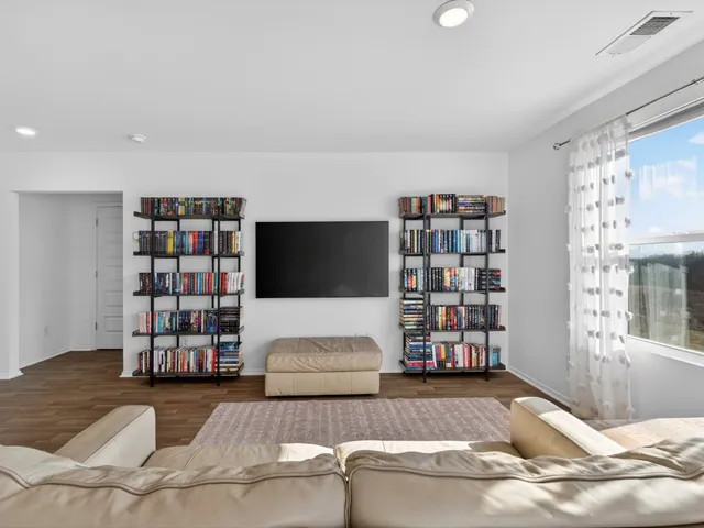a living room with furniture cabinets and window