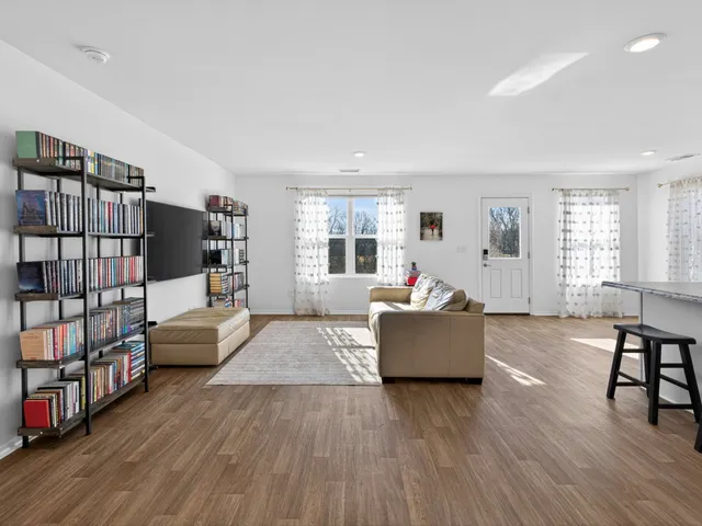a living room with furniture and a wooden floor
