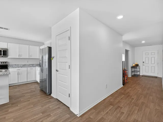 a view of a kitchen with a sink and a refrigerator
