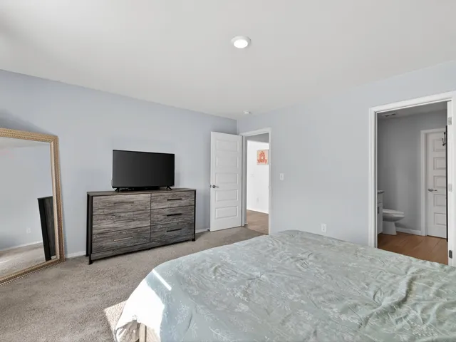 a bedroom with a bed and flat screen tv