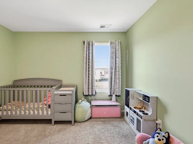 a bedroom with furniture and a window