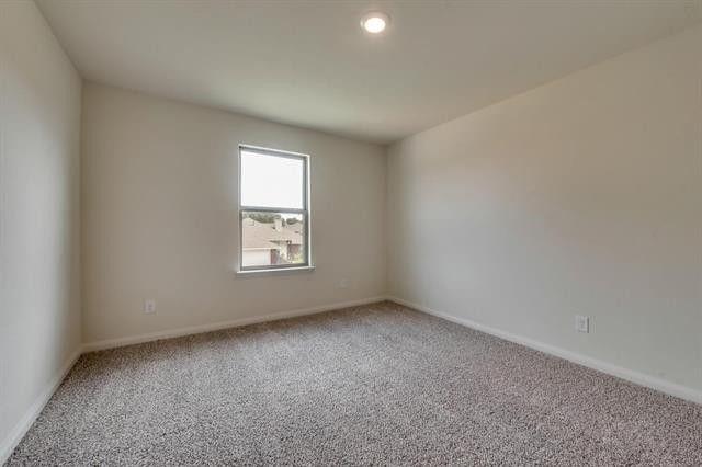 13609 Mineral Road Ponder, TX 76259 - Photo 10 of 21 Recessed lighting illuminates an interior space featuring neutral wall paint, a single window, and textured carpet flooring