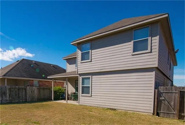 a view of a house with a backyard