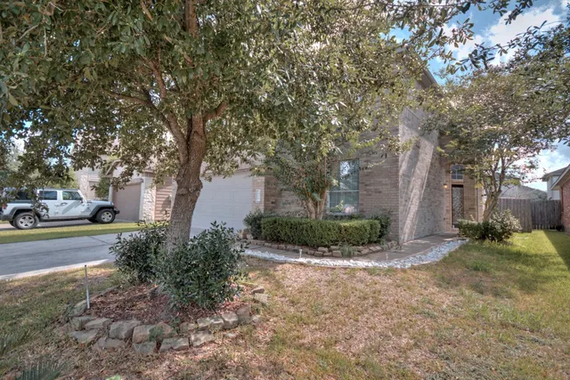 a view of a house with a yard and garage