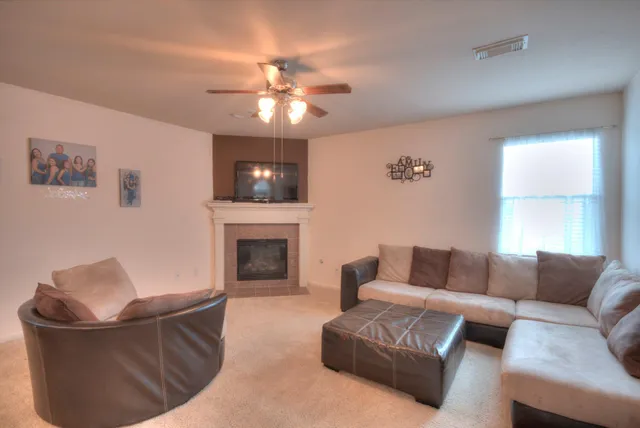 a living room with furniture and a fireplace