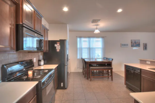 a kitchen with a cabinets and chairs