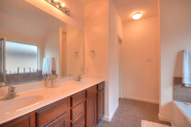 a bathroom with a double vanity sink and a mirror