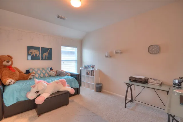 a bedroom with furniture and a window