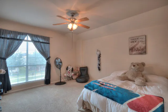 a bedroom with a bed and a chandelier