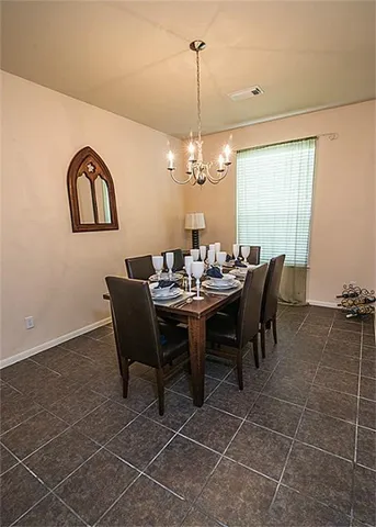 a view of a dining room with furniture and chandelier