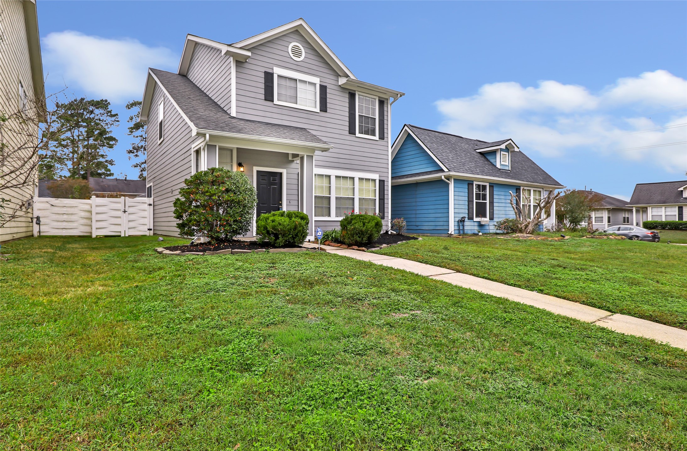 a view of a house with a yard and potted plants