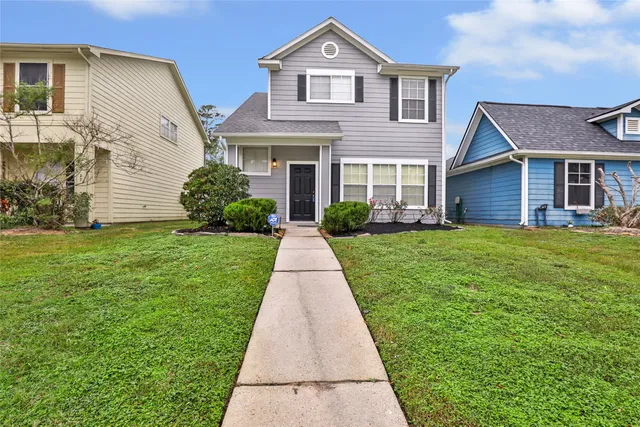 a front view of house with yard and green space