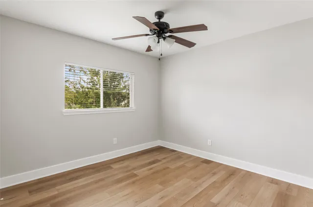 wooden floor in an empty room with a window