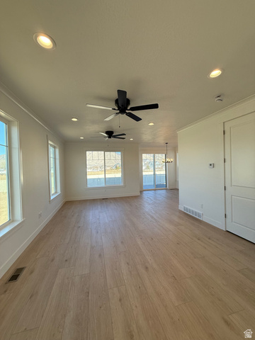 1142 West 220 North Mapleton, UT 84664 - Photo 9 of 26 Unfurnished living room with light wood-style floors, a ceiling fan, and a chandelier