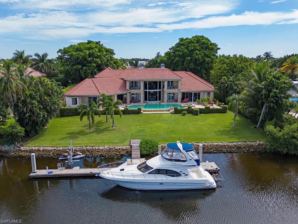 1030 Galleon Drive Naples, FL 34102 - Photo 1 of 24 a view of a lake with outdoor space