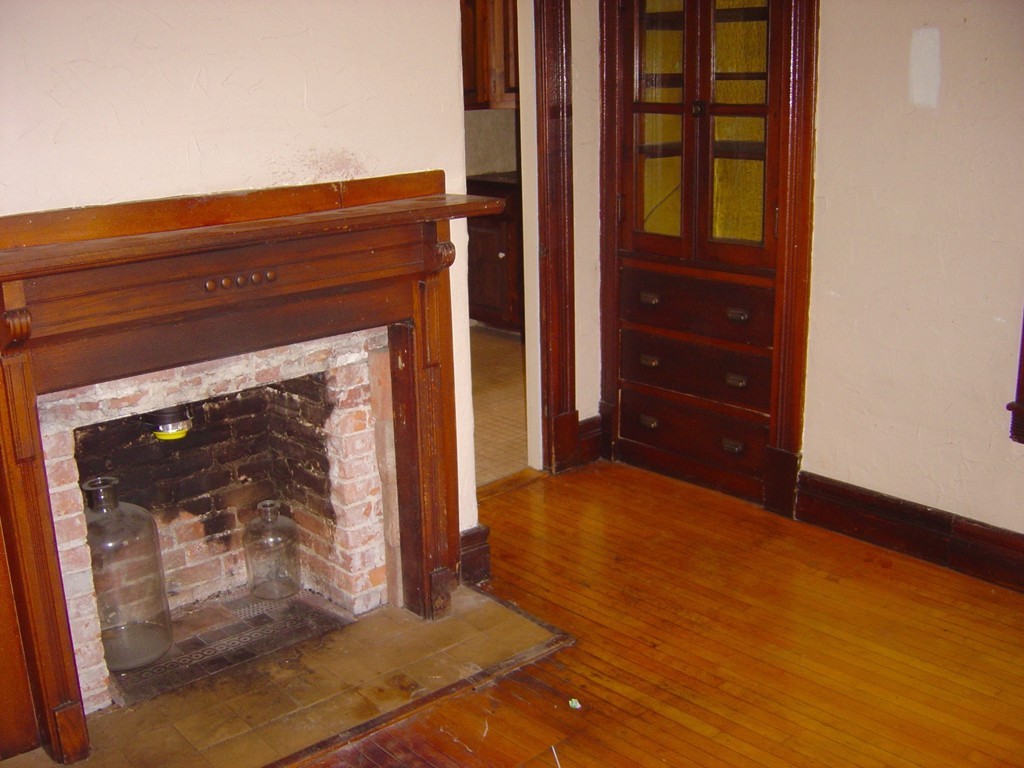 11 High Street Ware, MA 01082 - Photo 10 of 14 a view of an empty room with wooden floor and a fireplace