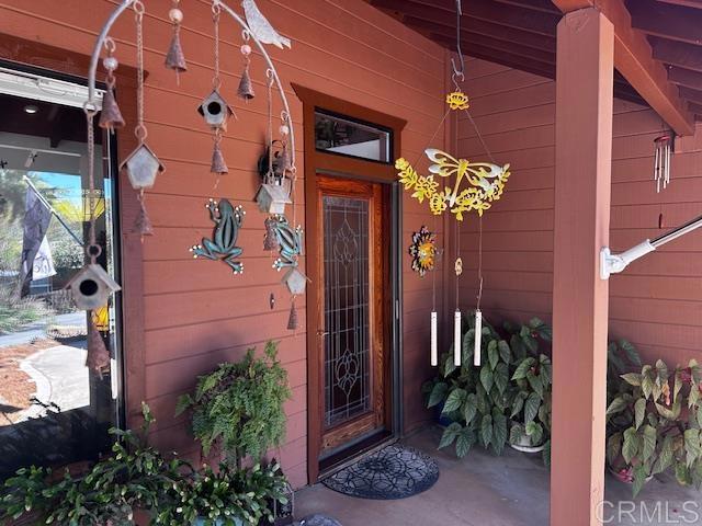 12993 Old Barona Road Lakeside, CA 92040 - Photo 1 of 48 a vase with flowers sitting on a floor in front of a door