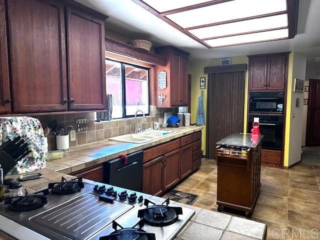 12993 Old Barona Road Lakeside, CA 92040 - Photo 11 of 48 a kitchen with a sink stove and cabinets