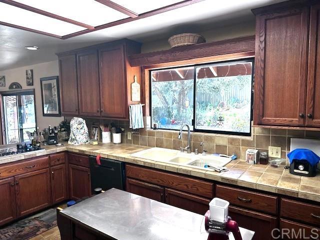 12993 Old Barona Road Lakeside, CA 92040 - Photo 12 of 48 a kitchen with a sink and wooden cabinets