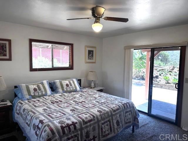 12993 Old Barona Road Lakeside, CA 92040 - Photo 20 of 48 a bedroom with a large bed and a chandelier