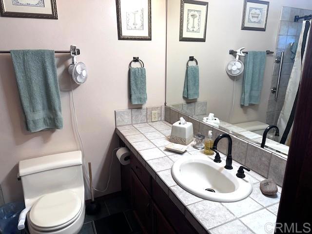 12993 Old Barona Road Lakeside, CA 92040 - Photo 21 of 48 a bathroom with a toilet sink and mirror